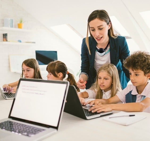 Teacher with kids on laptop copy-1