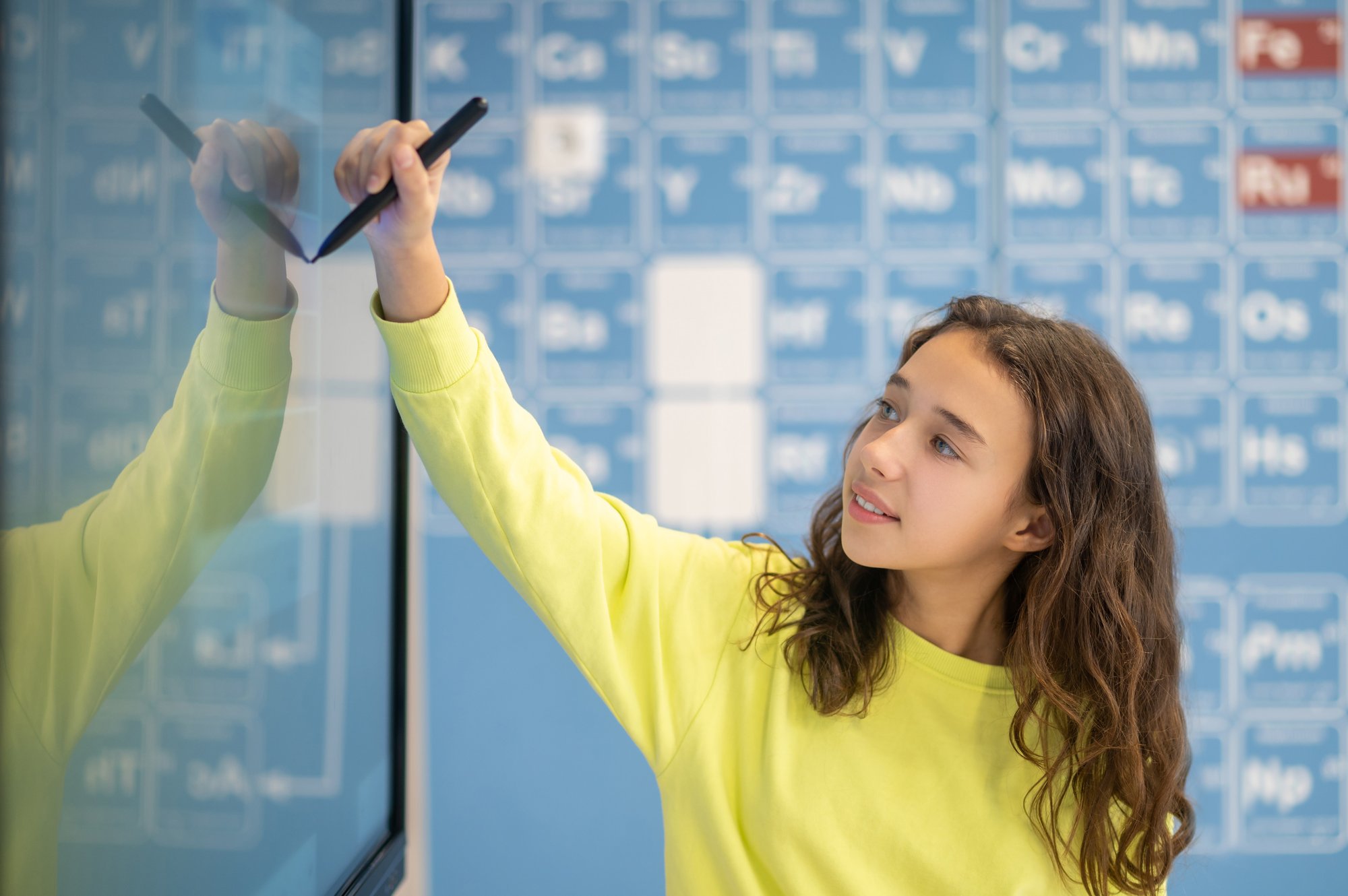 girl-drawing-with-marker-blackboard-classroom